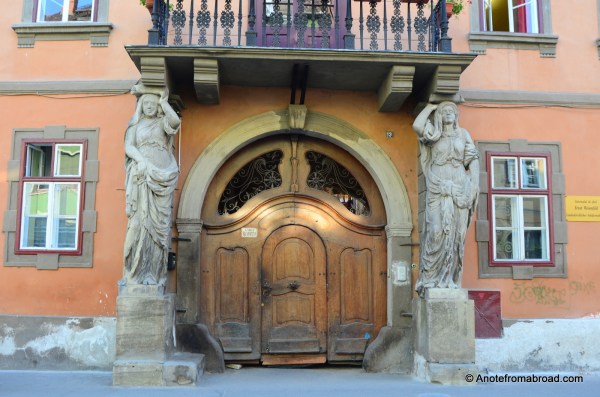 Massive columns guard this entry door