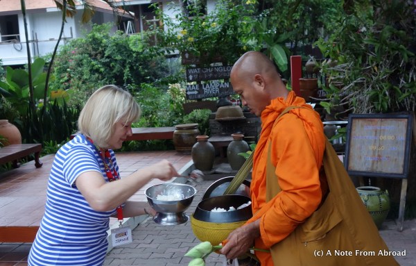 Putting rice into the alms bowl