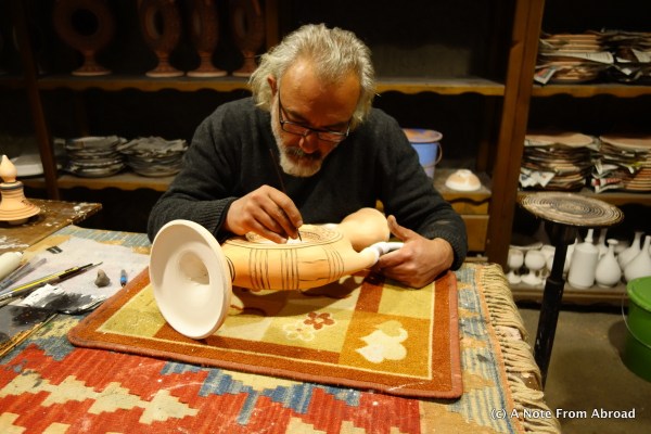 Artist is hand painting an intricate pattern