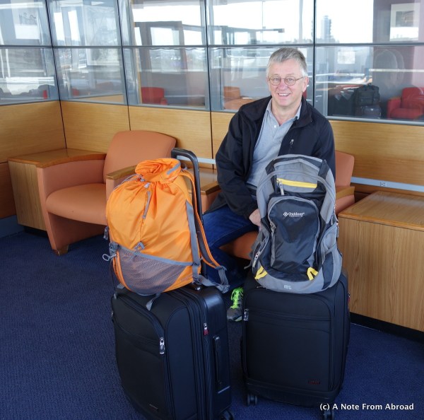 Tim at LAX with all of our luggage.  Two carry on size suitcases and two small backpacks.