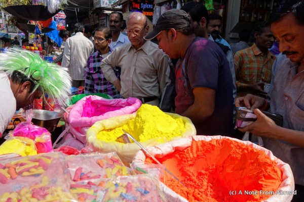 People lined up to buy colored powder and water balloons for Holi Festival
