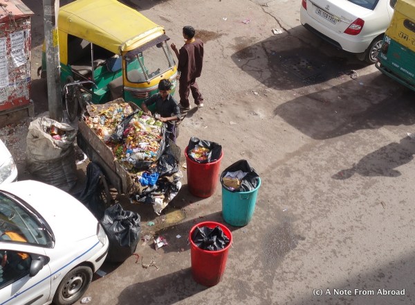 Recycling done by hand - worker sorts through  garbage to take out plastic and paper items