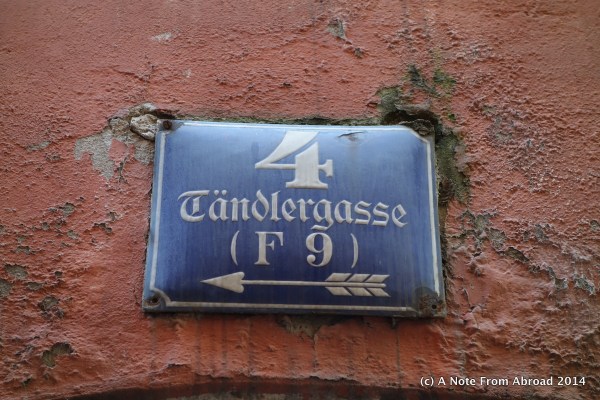 Street sign, address on the side of a building