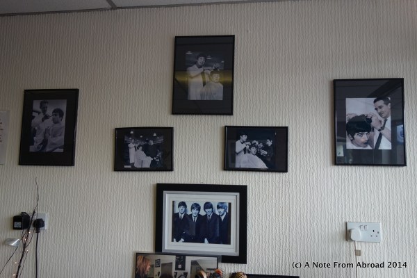Pictures of The Beatles getting their hair cut inside the Penny Lane Barber Shop