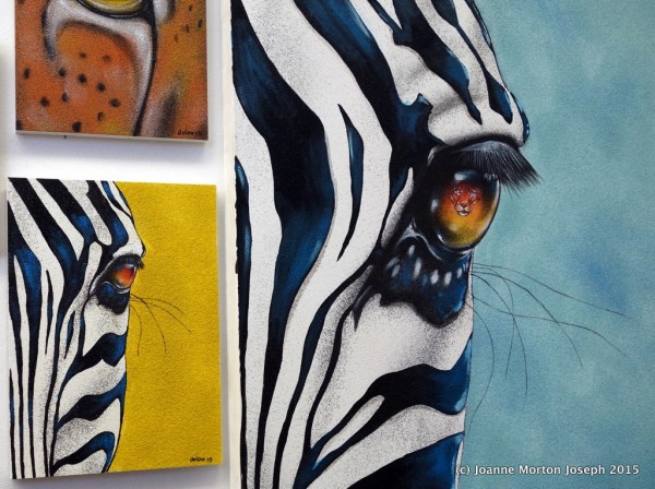 Examples of sand painting. The zebra on the right has a lion reflected in the eye. 