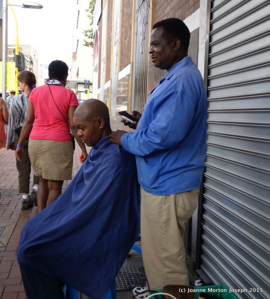 Getting a hair cut right out on the sidewalk