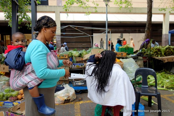 Buy some fruit or get your hair braided in the market place. Hair braiding offered