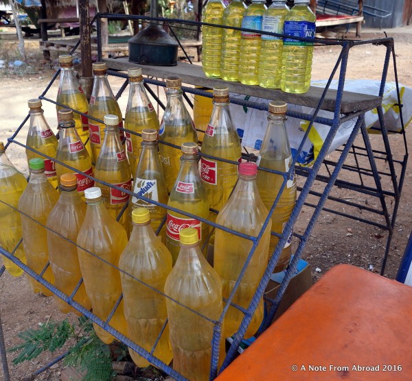 Gasoline being sold roadside in plastic soda bottles