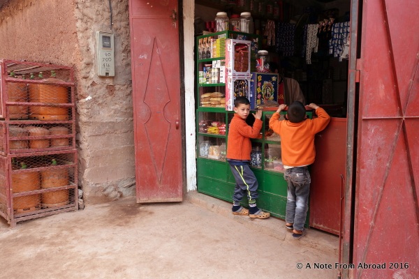 Two young boys peering into the tiny store