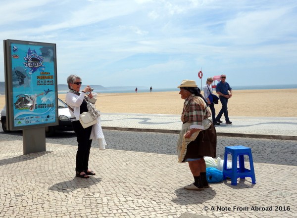 Showing traditional headscarf and embroidered aprons over seven flannel skirts