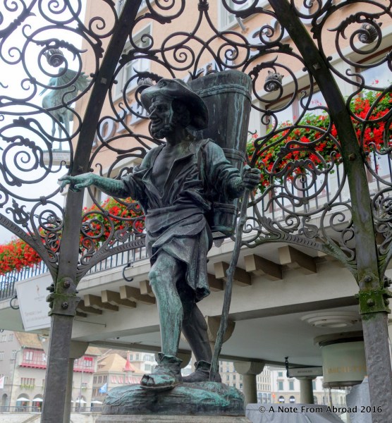 Statue of wine picker on one of many fountains that dot this city